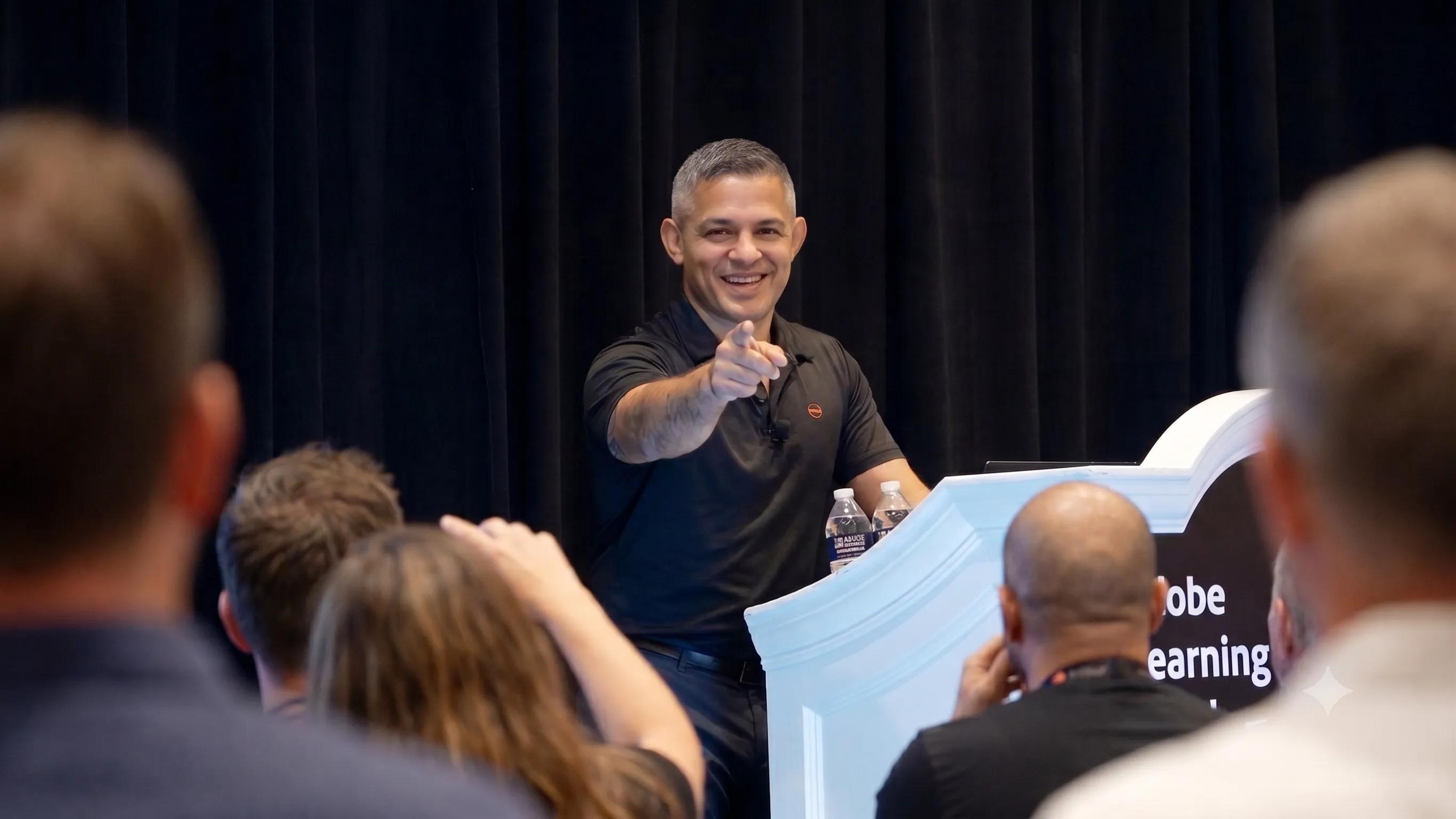 Erick Prospero presenting on stage at the Adobe Learning Summit
